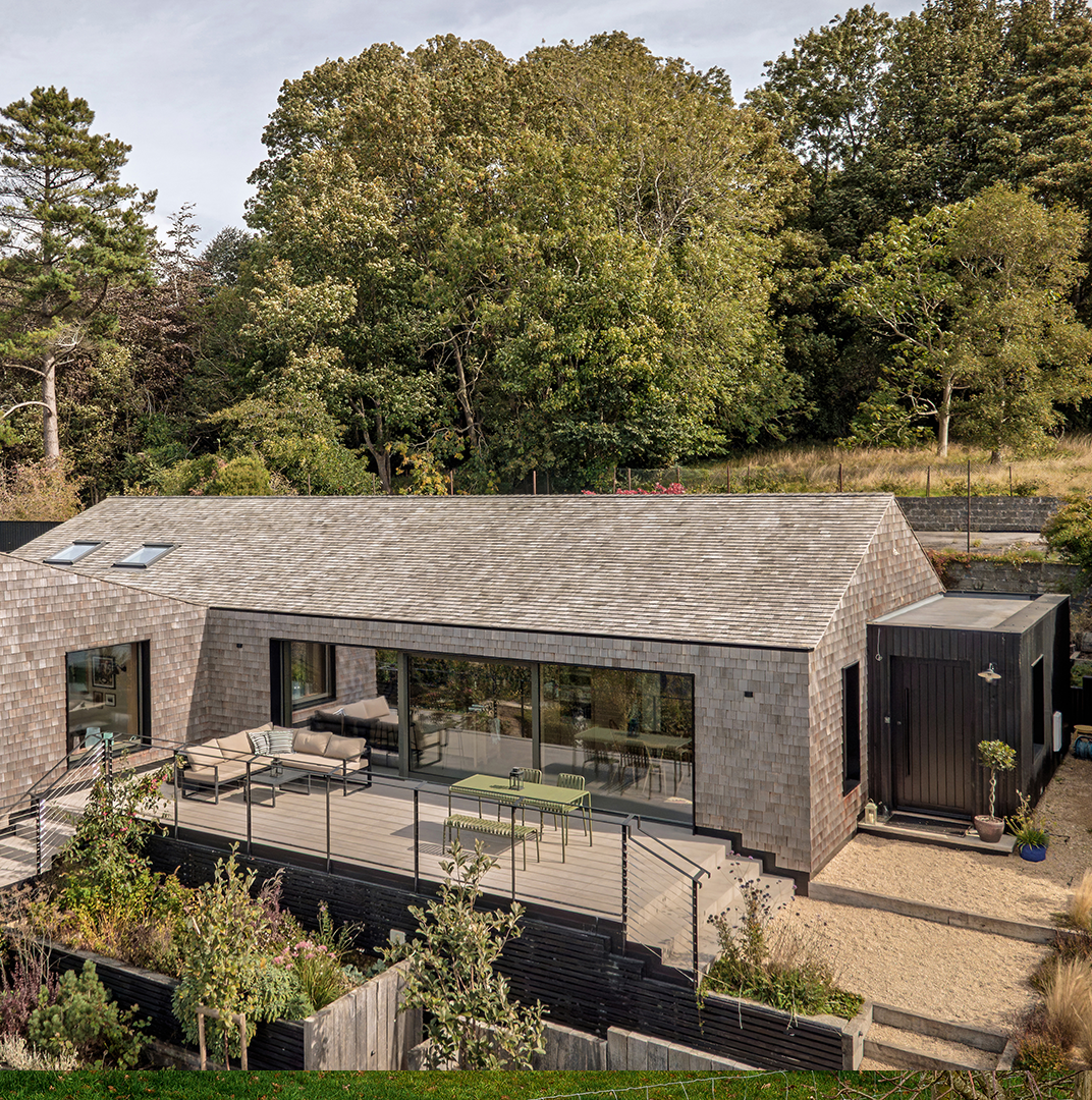 Self-Build House with solar panels on the roof and built with timber
