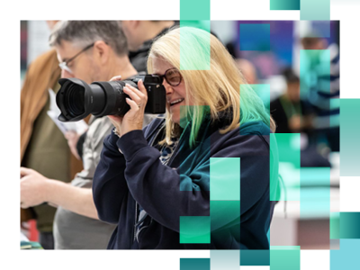 Visitor and exhibitor with camera