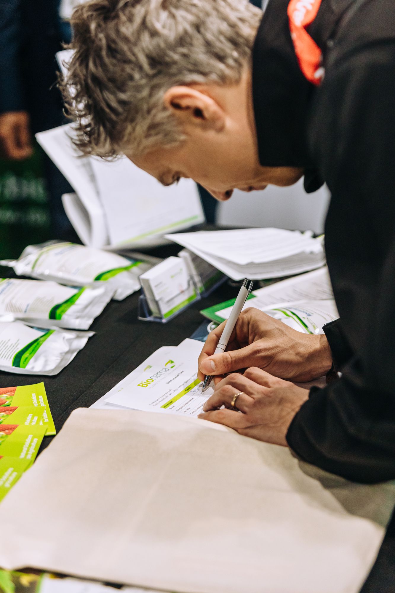 Man writing on paper with pen in right hand