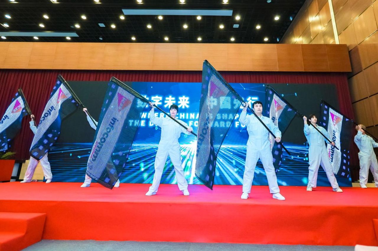 lady with sunglasses speaks into microphone