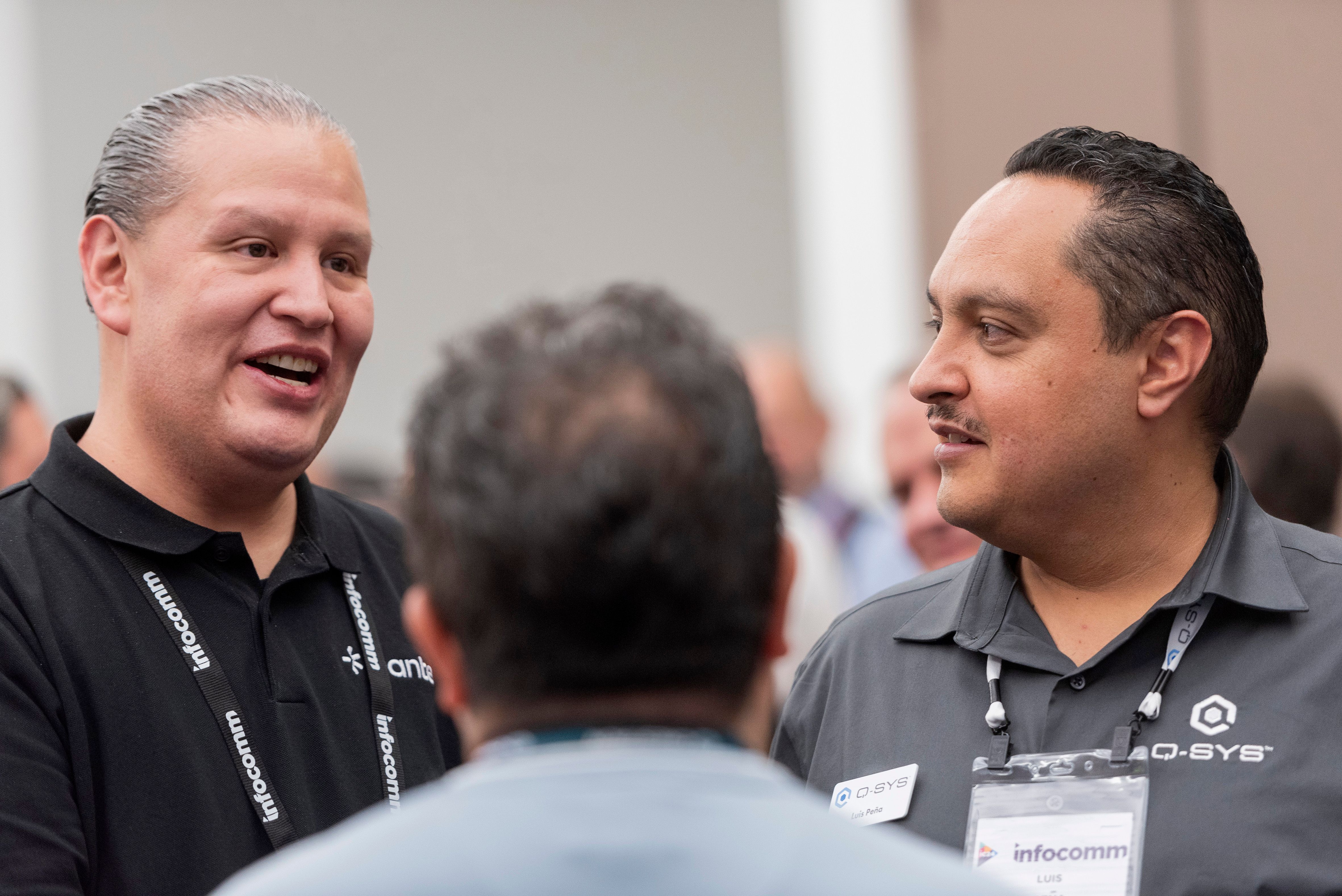 InfoComm exhibitor shows its products to a visitor at its booth