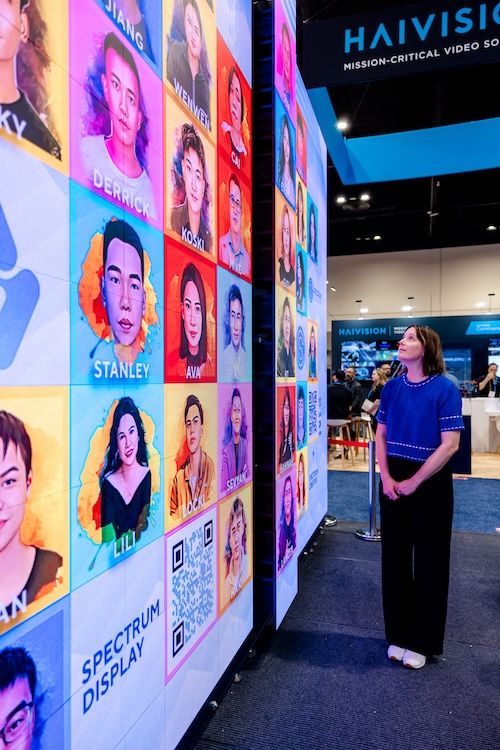 Woman observing digital signage at InfoComm 2025