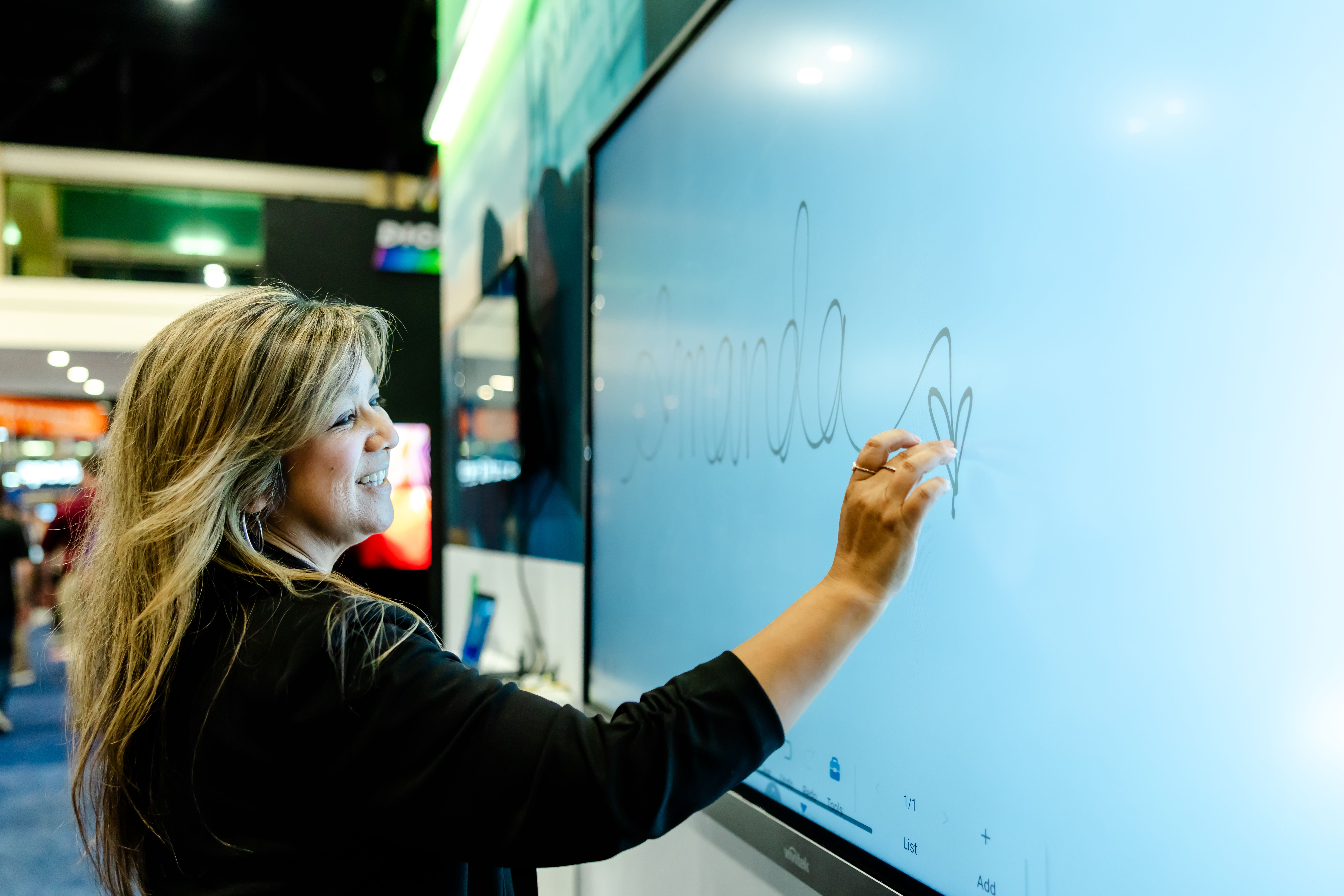 InfoComm exhibitor using their clear interactive board for learning spaces