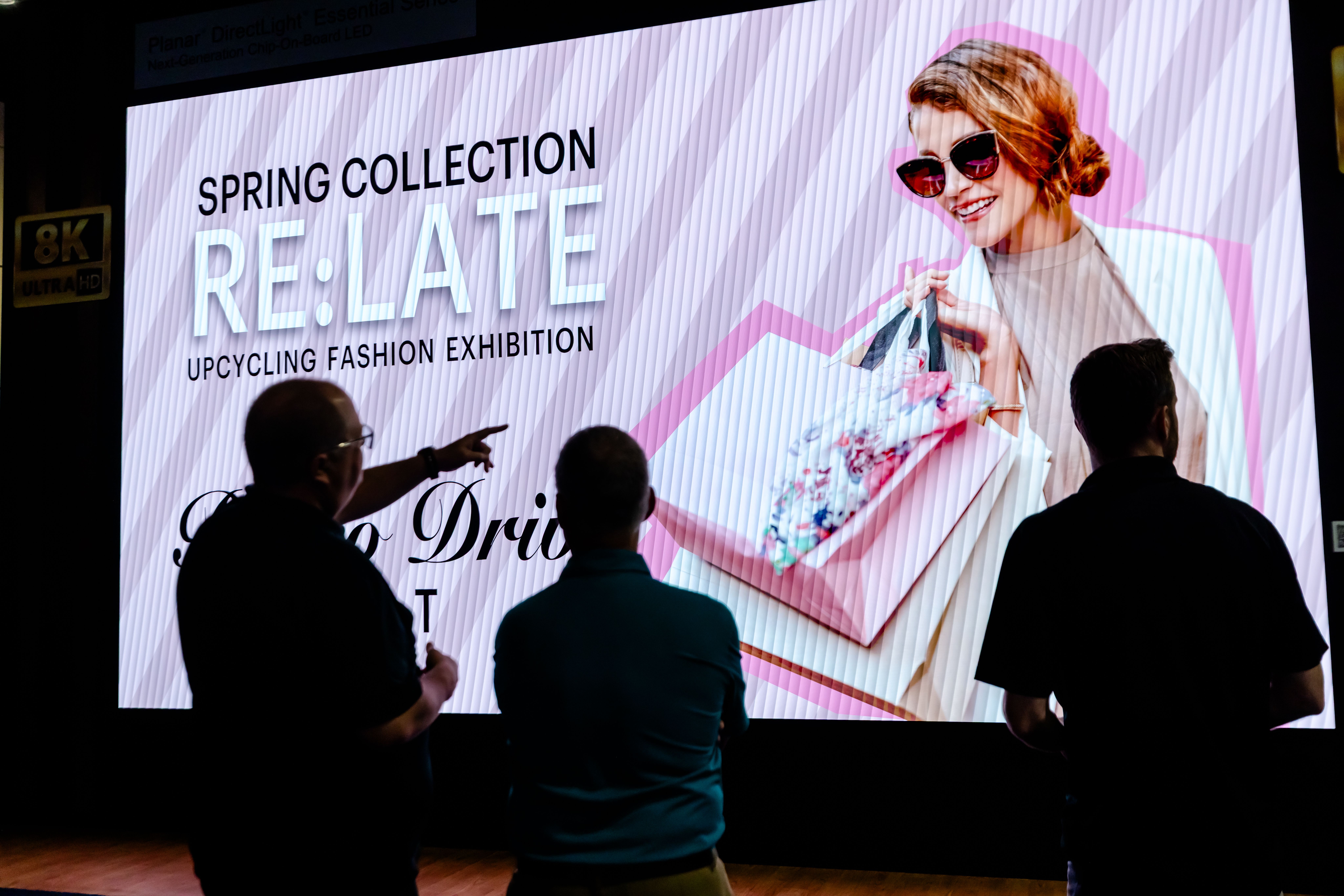 People looking at retail digital signage display