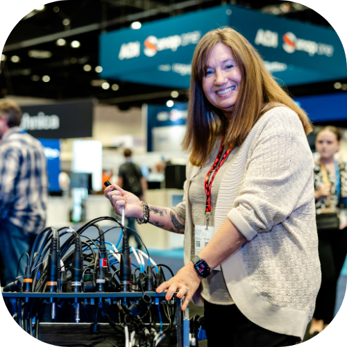 An InfoComm attendee tries out audio equipment in the exhibit hall