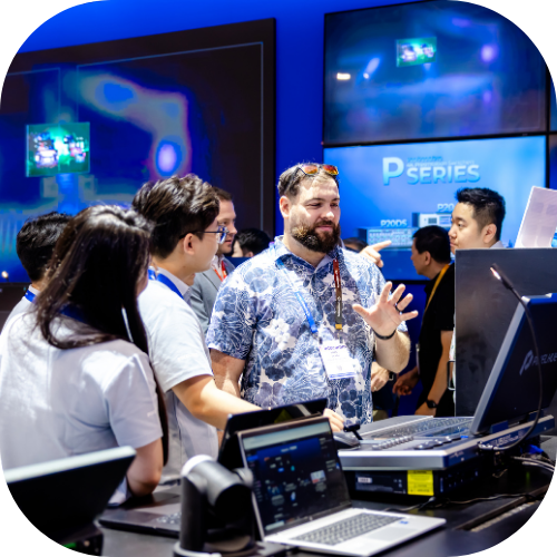 InfoComm attendees trying new pro AV tech in an exhibitor's booth