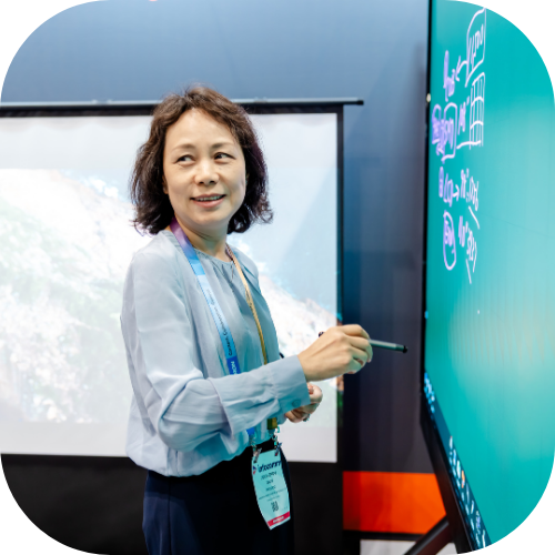 An InfoComm attendee a smart board designed for learning spaces on the show floor