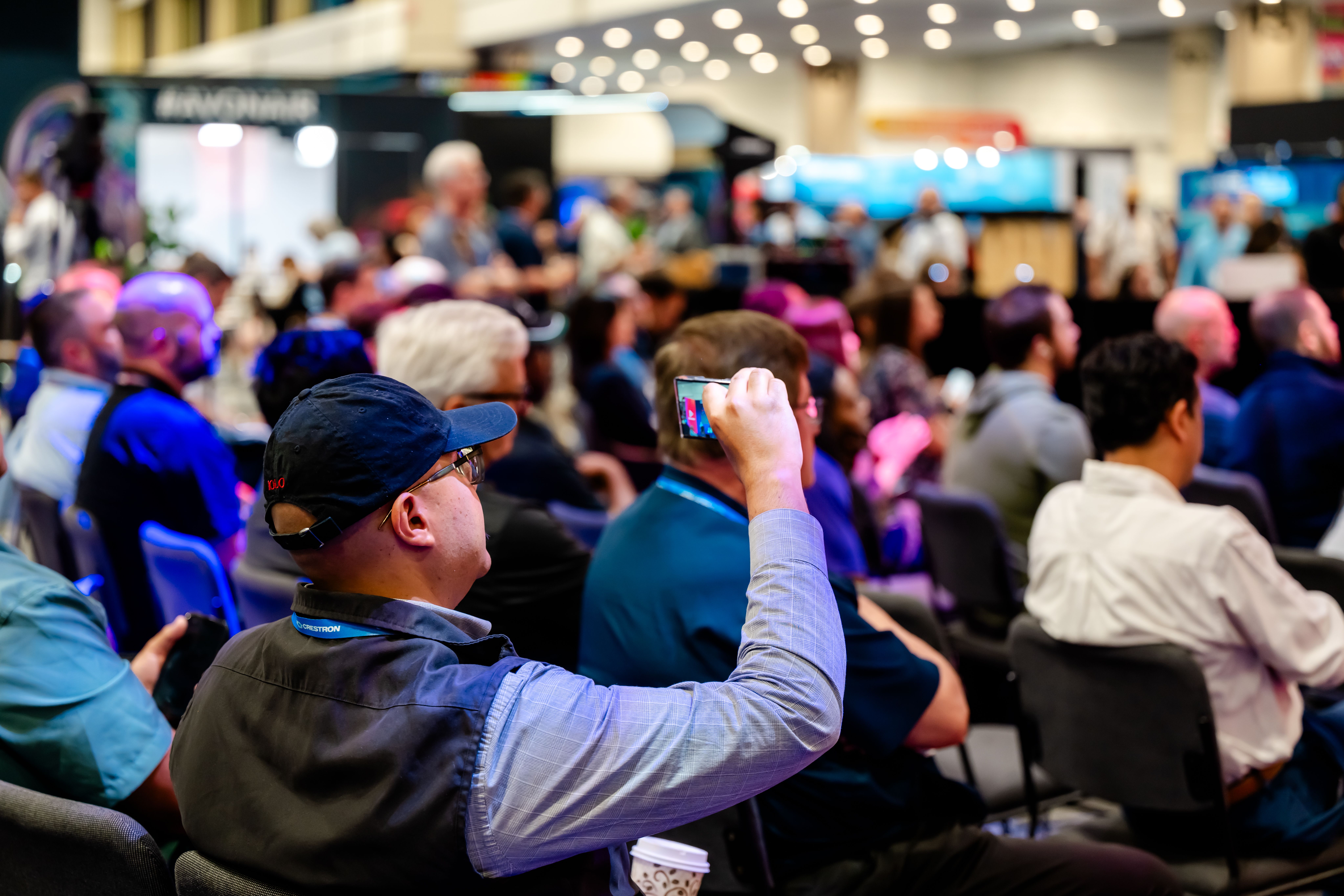 Man taking photo during exhibit hall session