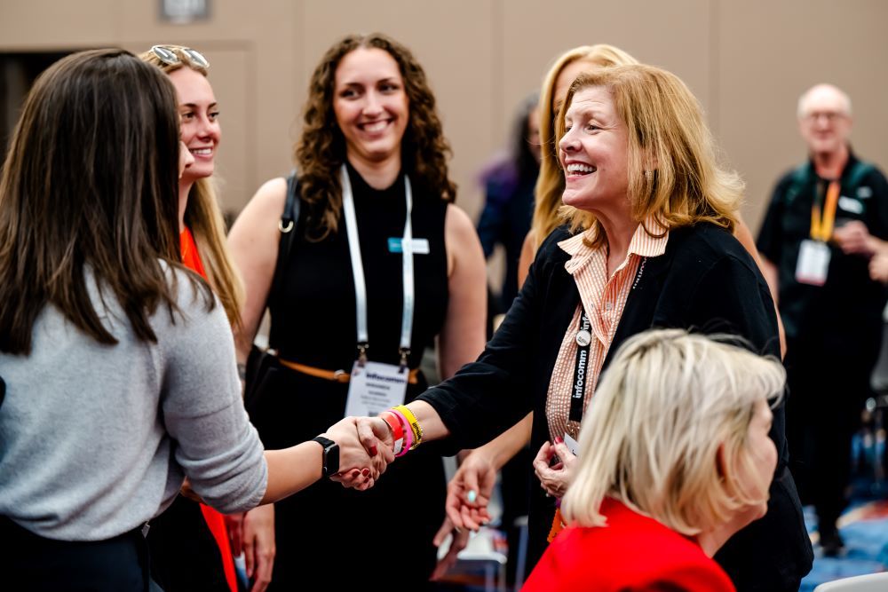 Two InfoComm attendees shaking hands