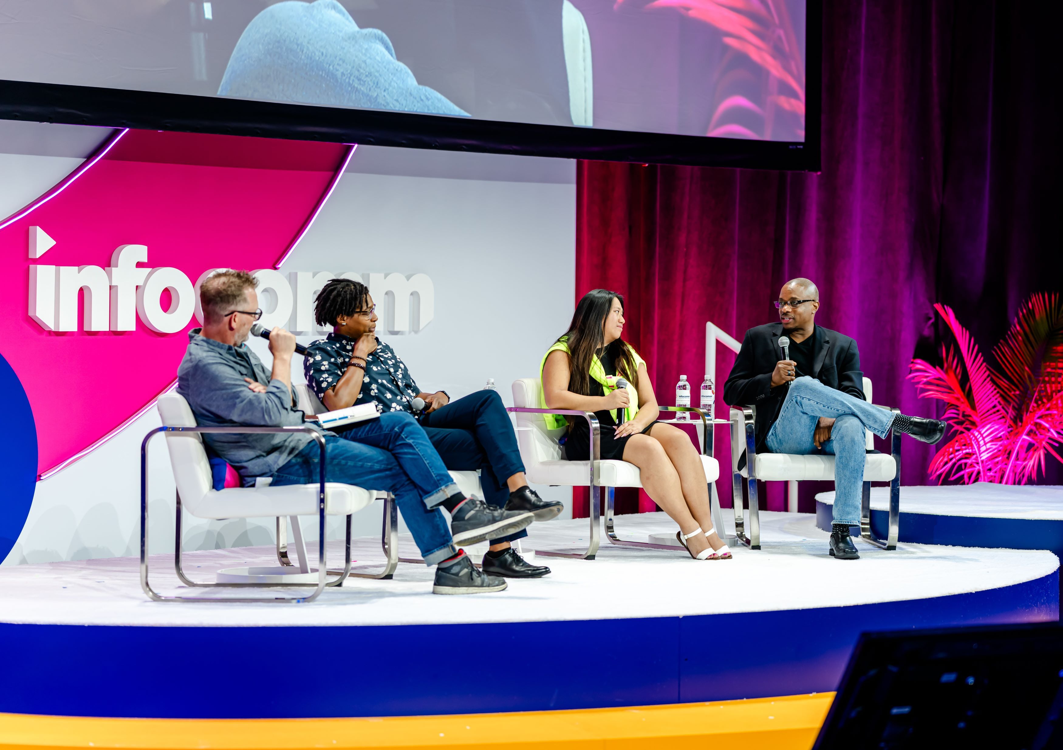 A panel on the InfoComm Technology Innovation stage talk with one another