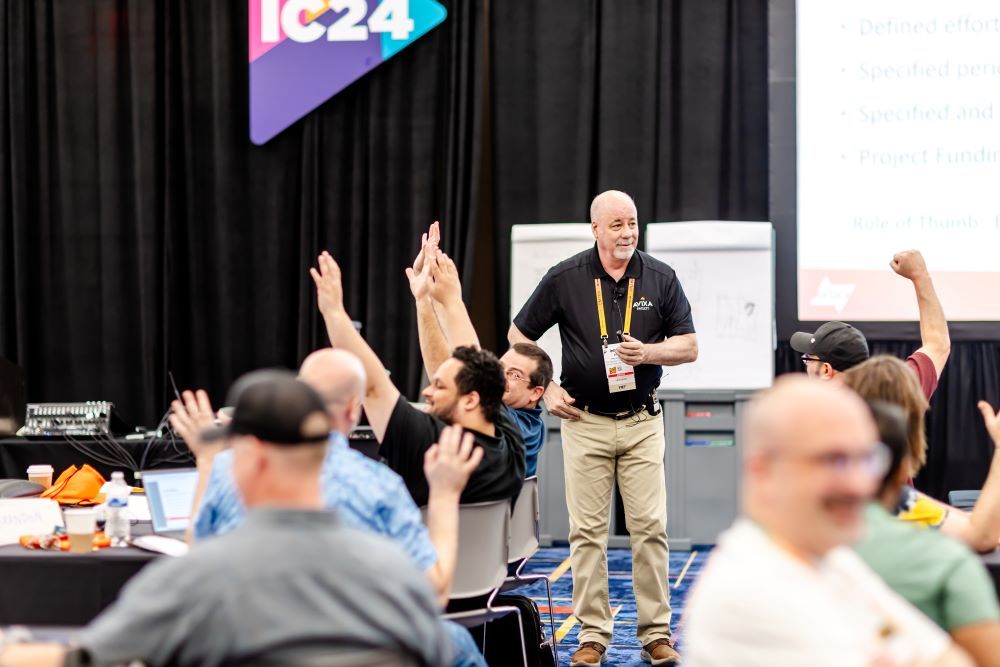 InfoComm students raise their hands during a training session