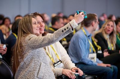 Delegates enjoy selfie at The AI Summit London 2024