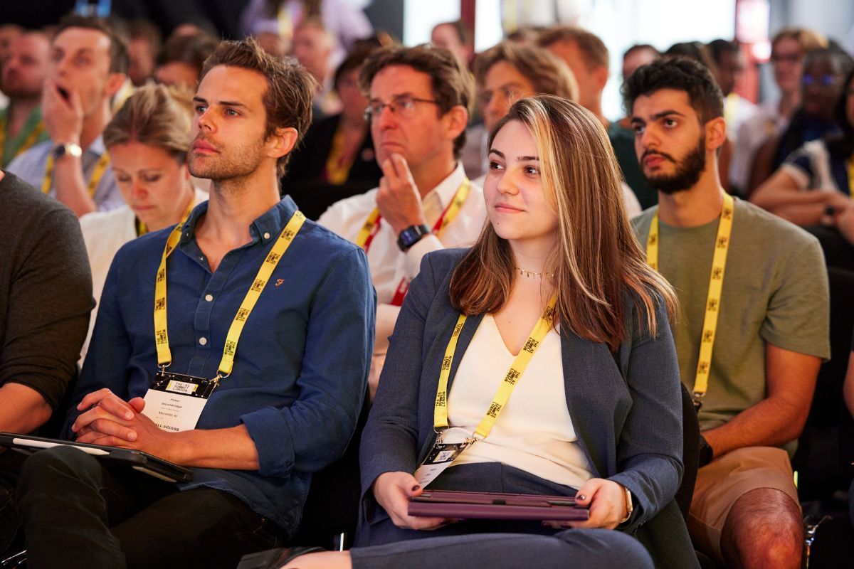 Two people in audience listening