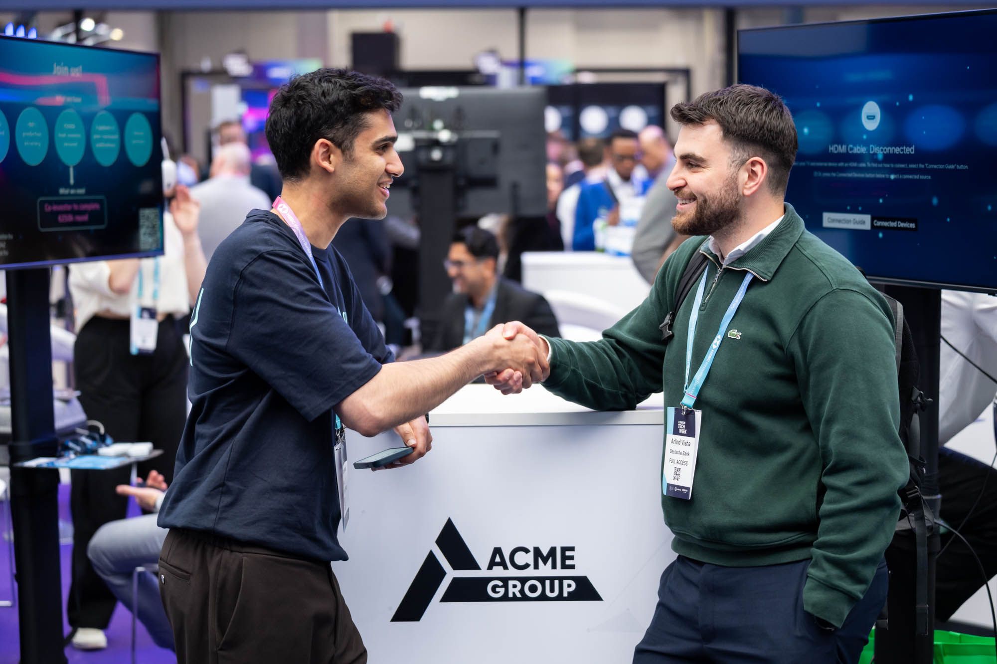 Two men networking and chatting onsite at London Tech Week 2026