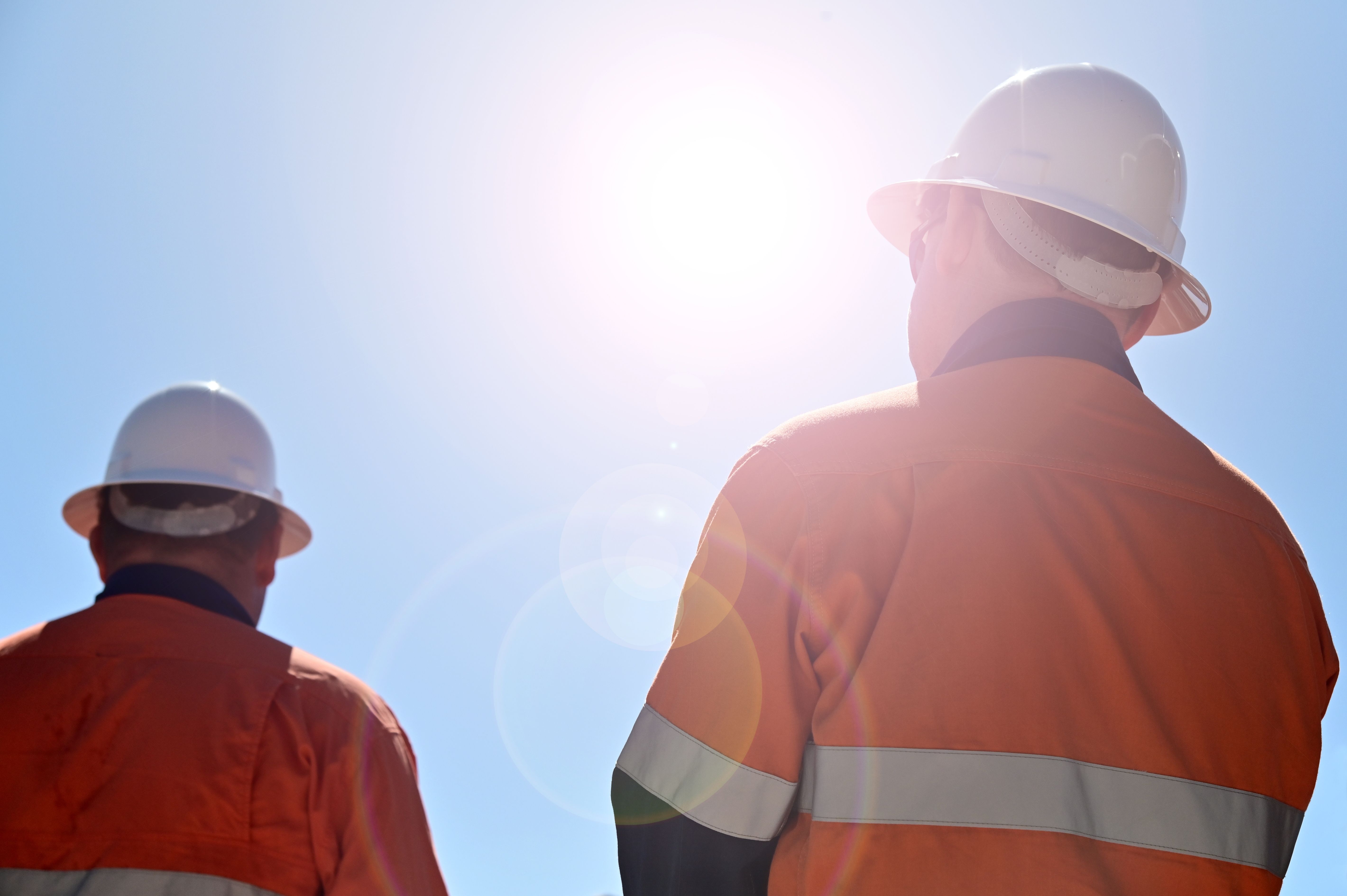 Two workers, blue skies