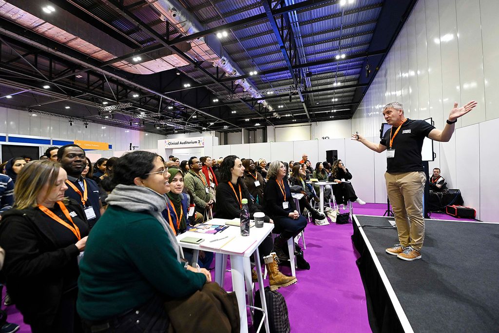 Audience image facing presenter on stage