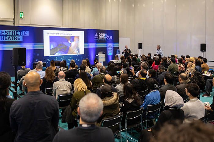 Dental professionals attend dental show on innovations in cosmetic dentistry and facial aesthetics.