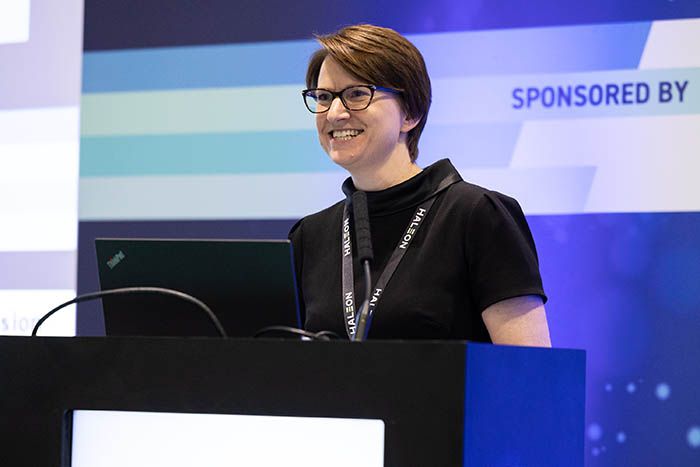 A dental professional presents at a dentistry conference on the latest restorative techniques.