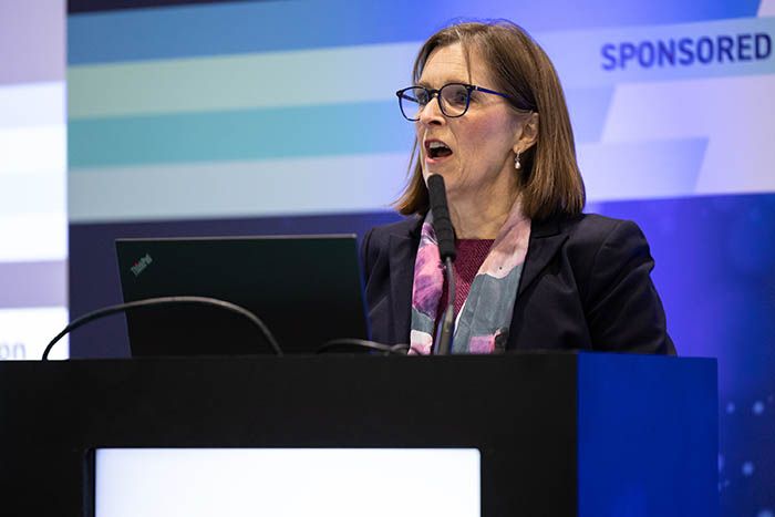 A dental professional presents at a dentistry conference on the latest restorative techniques.