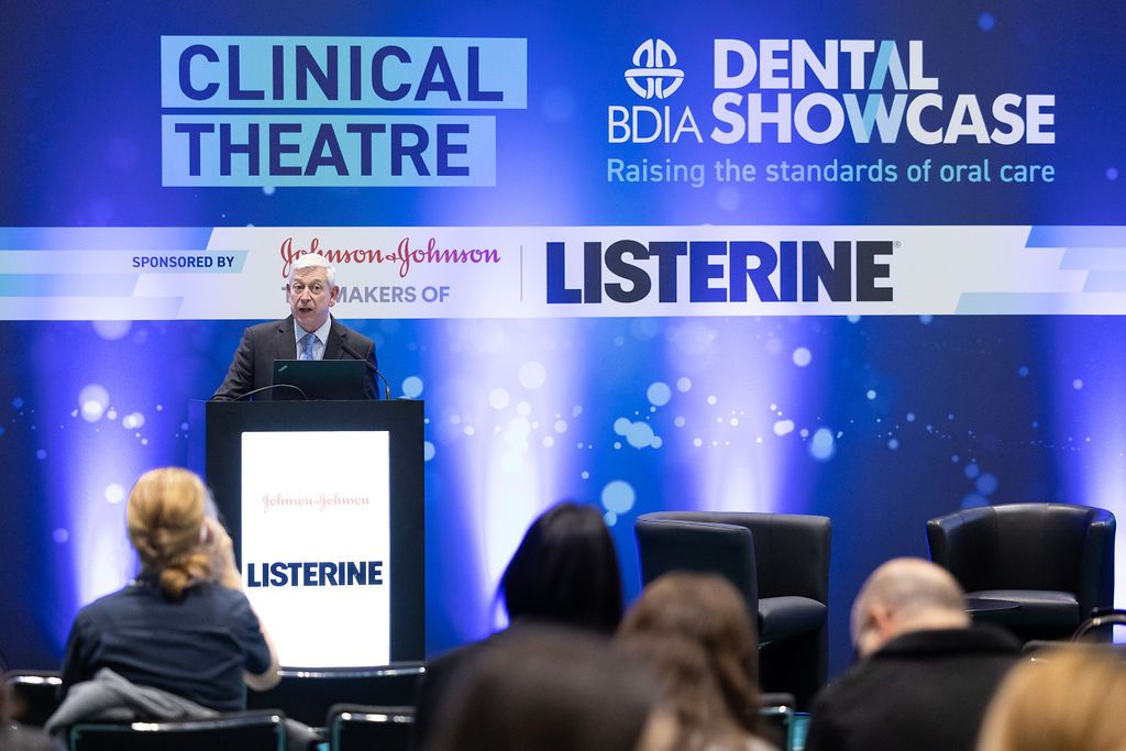 A dental professional presents at a dentistry conference on the latest restorative techniques.