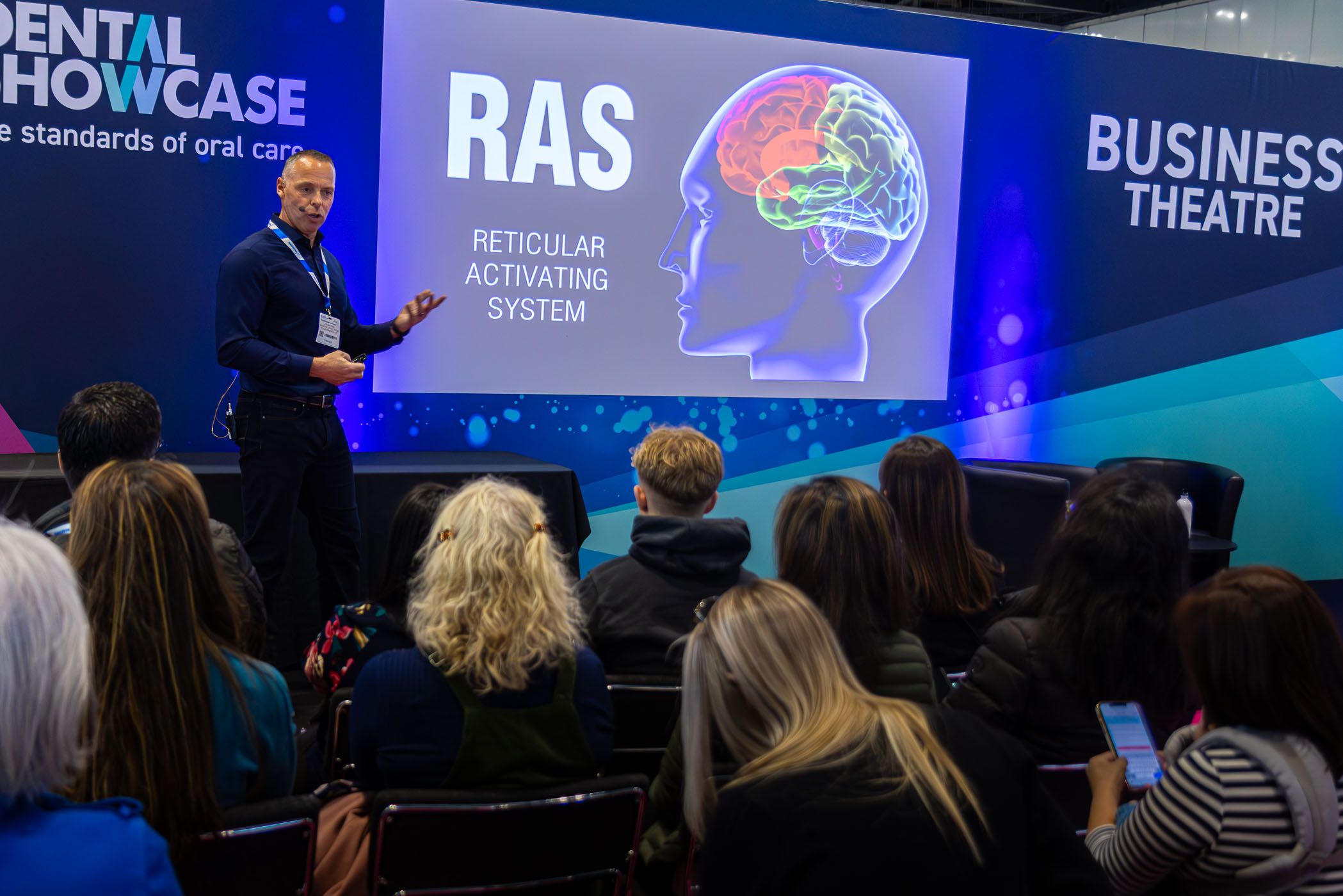 A dentistry expert delivers a presentation to an audience of dentists and odontologists at the BDIA Dental Showcase conference.