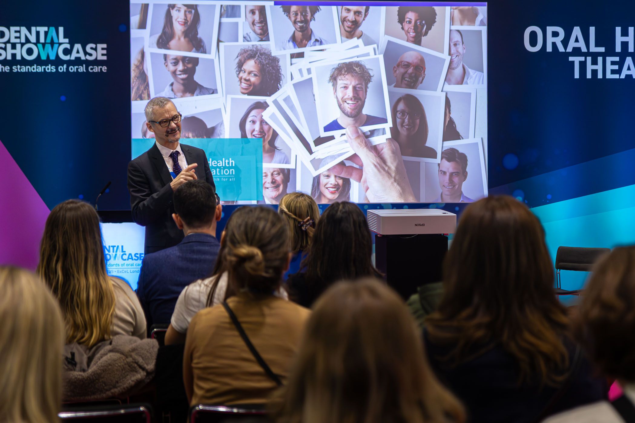 A young dental clinical professional addresses an audience of expert dentists and odontologists with a speech about dental compliance at the Oral Health Theatre during the BDIA Dental Showcase conference.