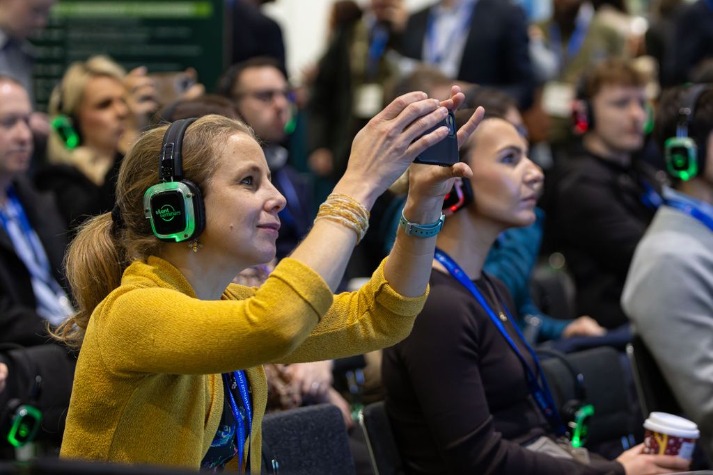 Lady taking photo during conference session