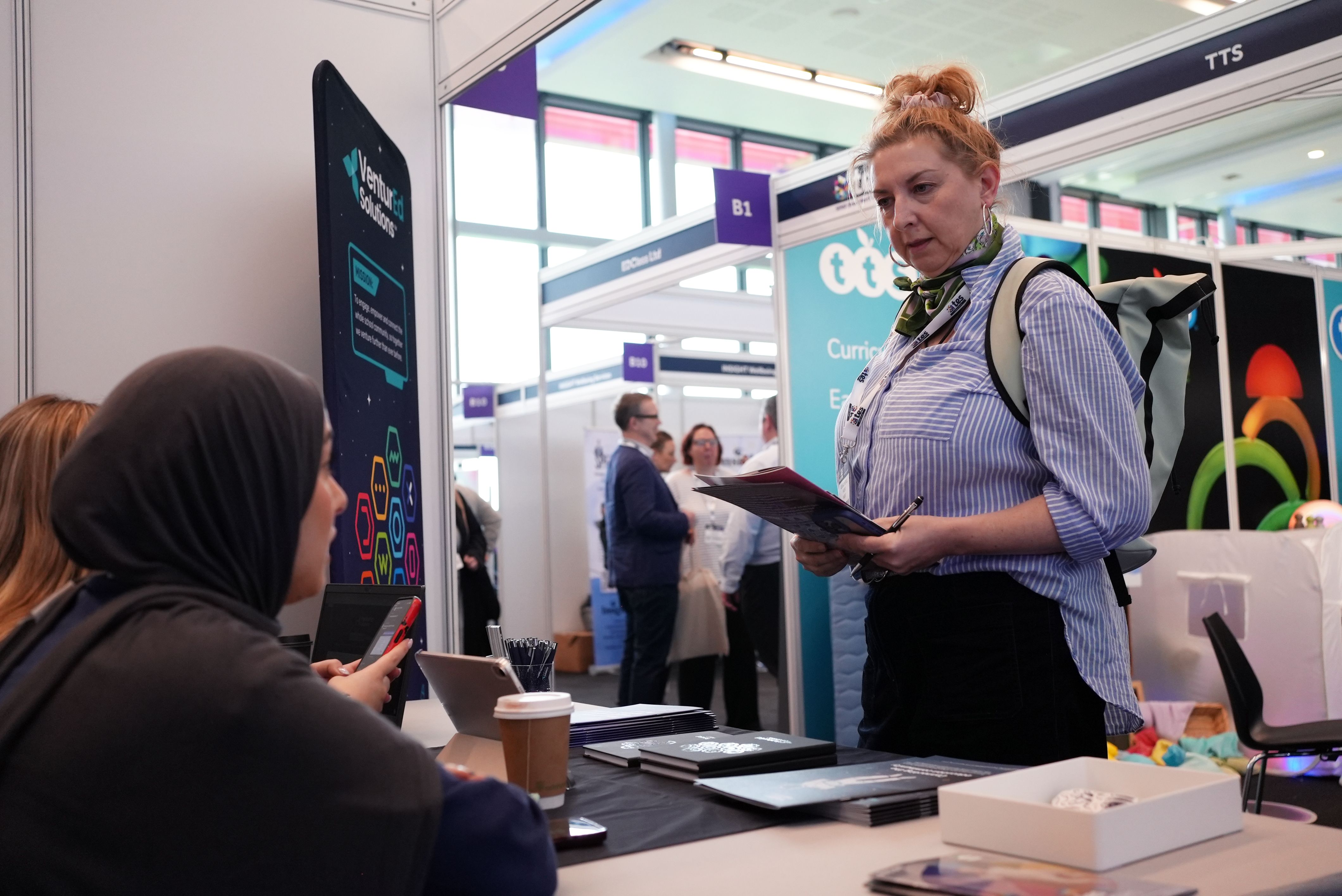 people talking to exhibitor