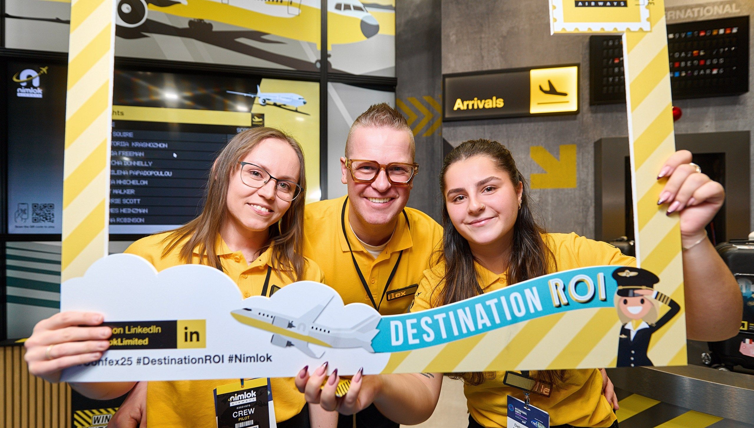 three nimlok employees in a selfie frame with destination ROI in text