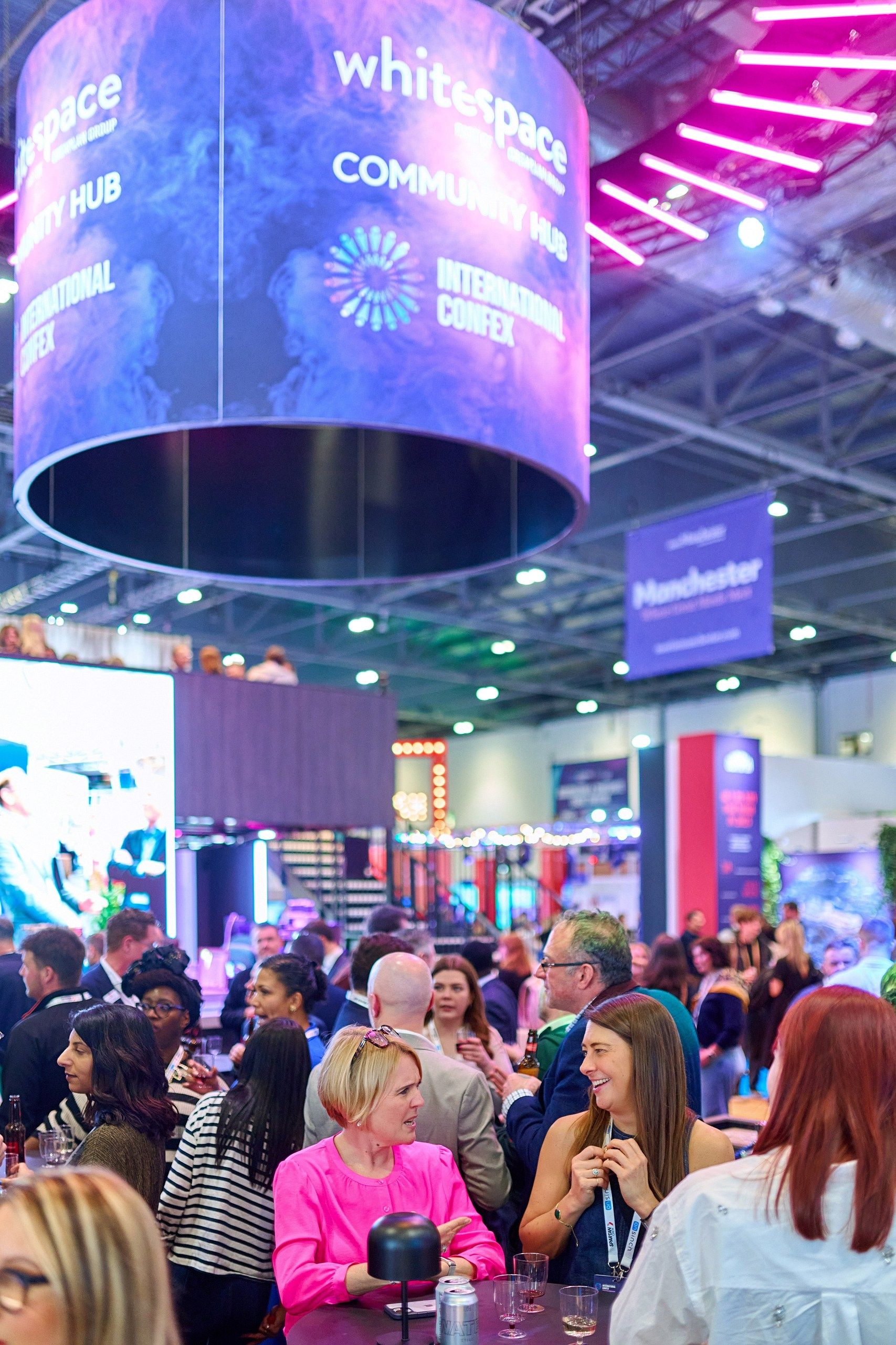 Confex attendees at the community hub catching up