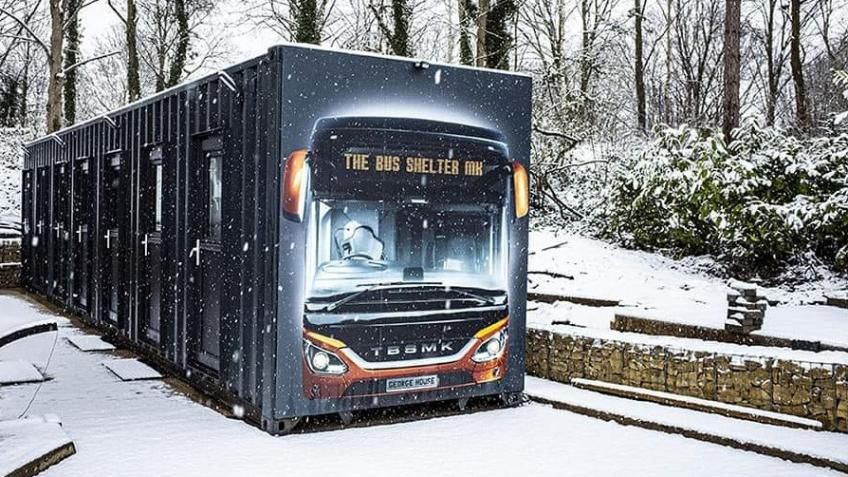 Container homes with bus image on in the snow 