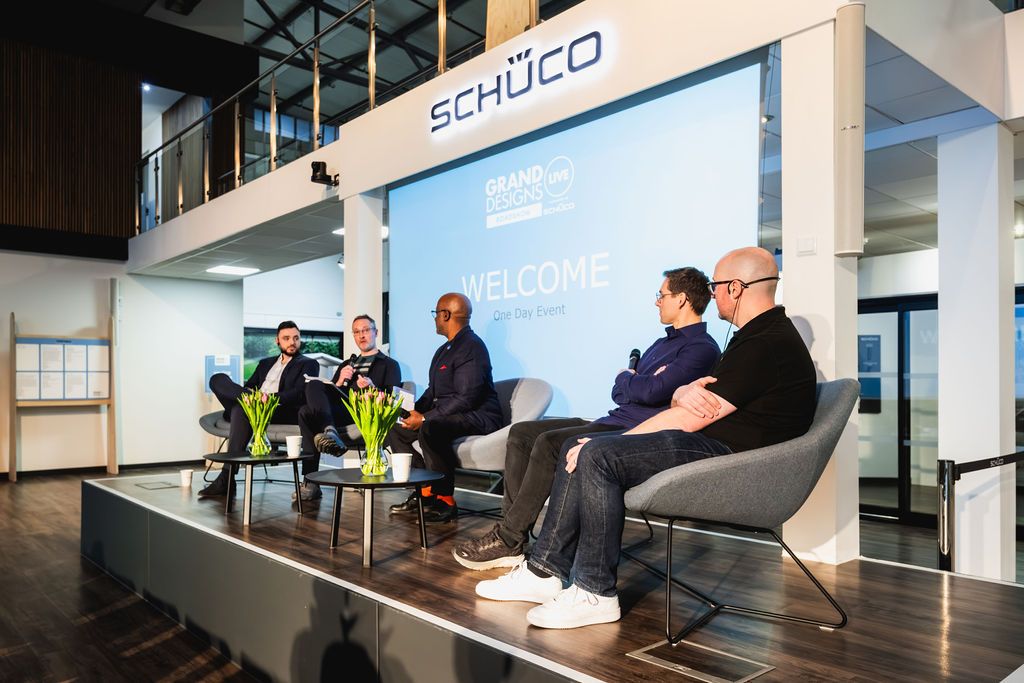 An expert talking to visitors in booth