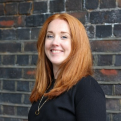 A woman with red hair smiling