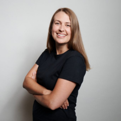 A woman smiling folding her arms