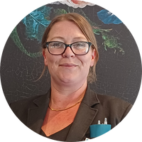 Headshot of a woman wearing a suit against a black background