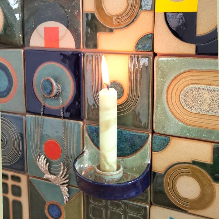 Handmade ceramic tiles with sculptural utilitarian elements.