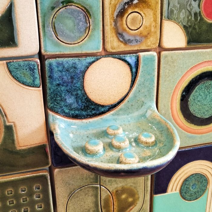 Handmade ceramic tiles with sculptural utilitarian elements.