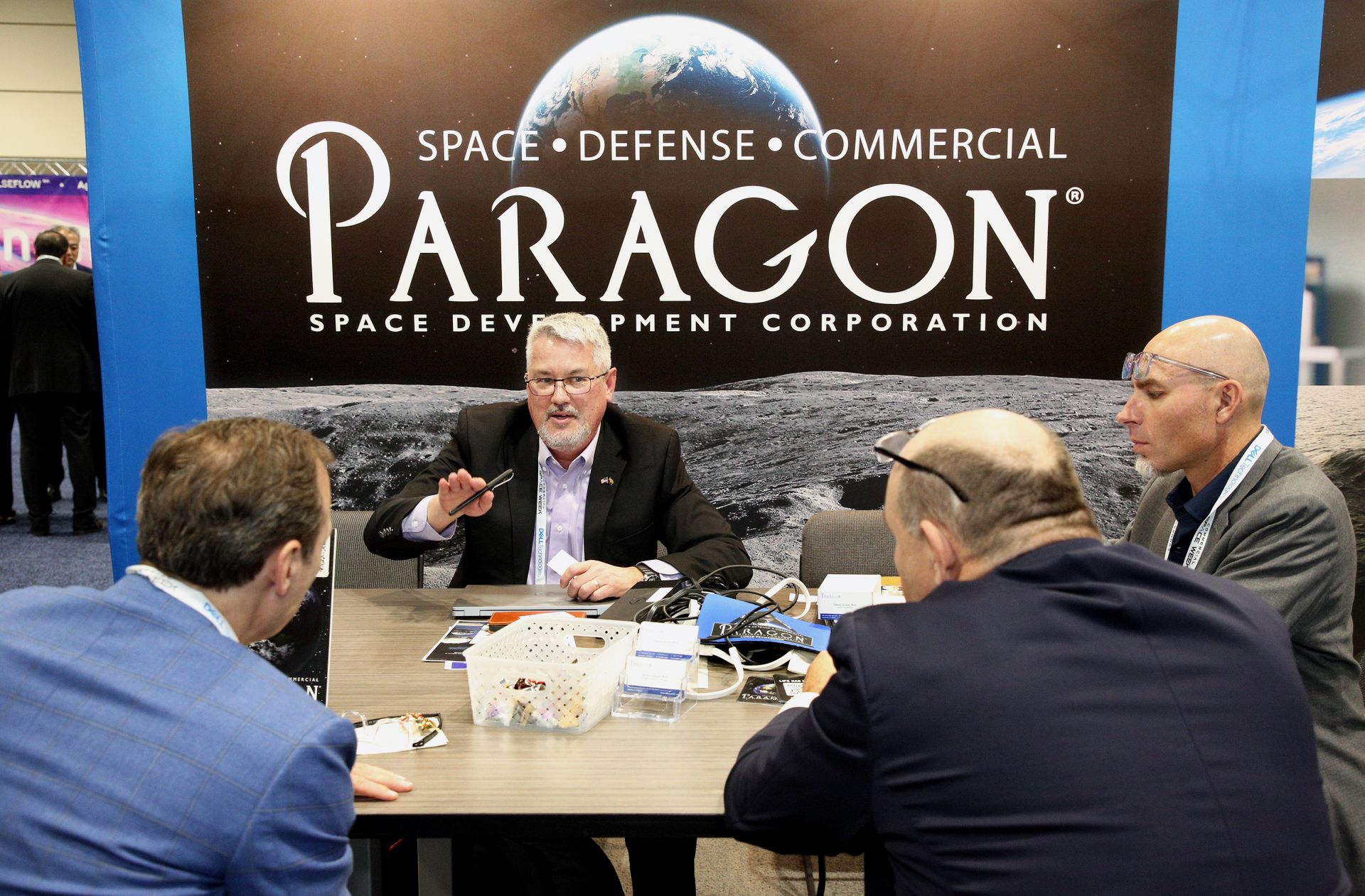 Four people discussing a poster