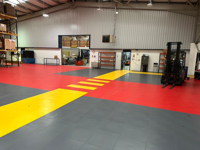 Safety floor layouts and messages using interlocking floor tiles