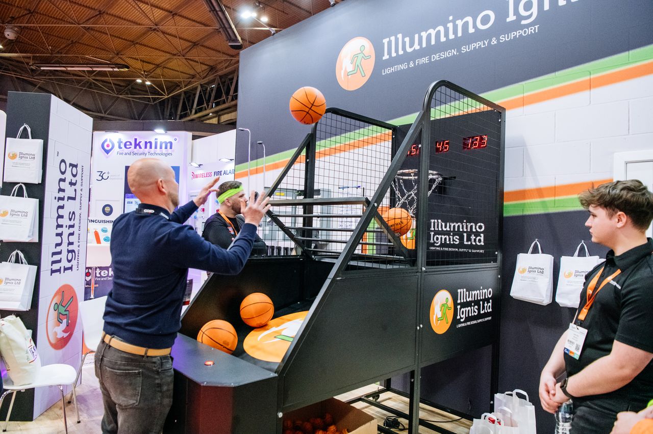 The Fire Safety Event Asia visitors playing a basketball arcade game