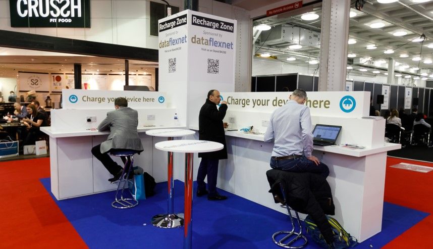 A photo of Business Travel Show Europe attendees using the recharge area