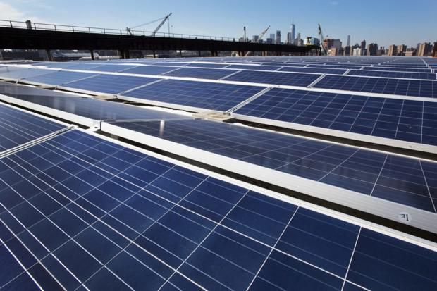A rooftop covered with solar panels at the Brooklyn Navy Yard in New York. For cities to go carbon neutral, off-site renewable energy as well as urban solar panels and wind turbines will be key. (Mark Lennihan/AP)