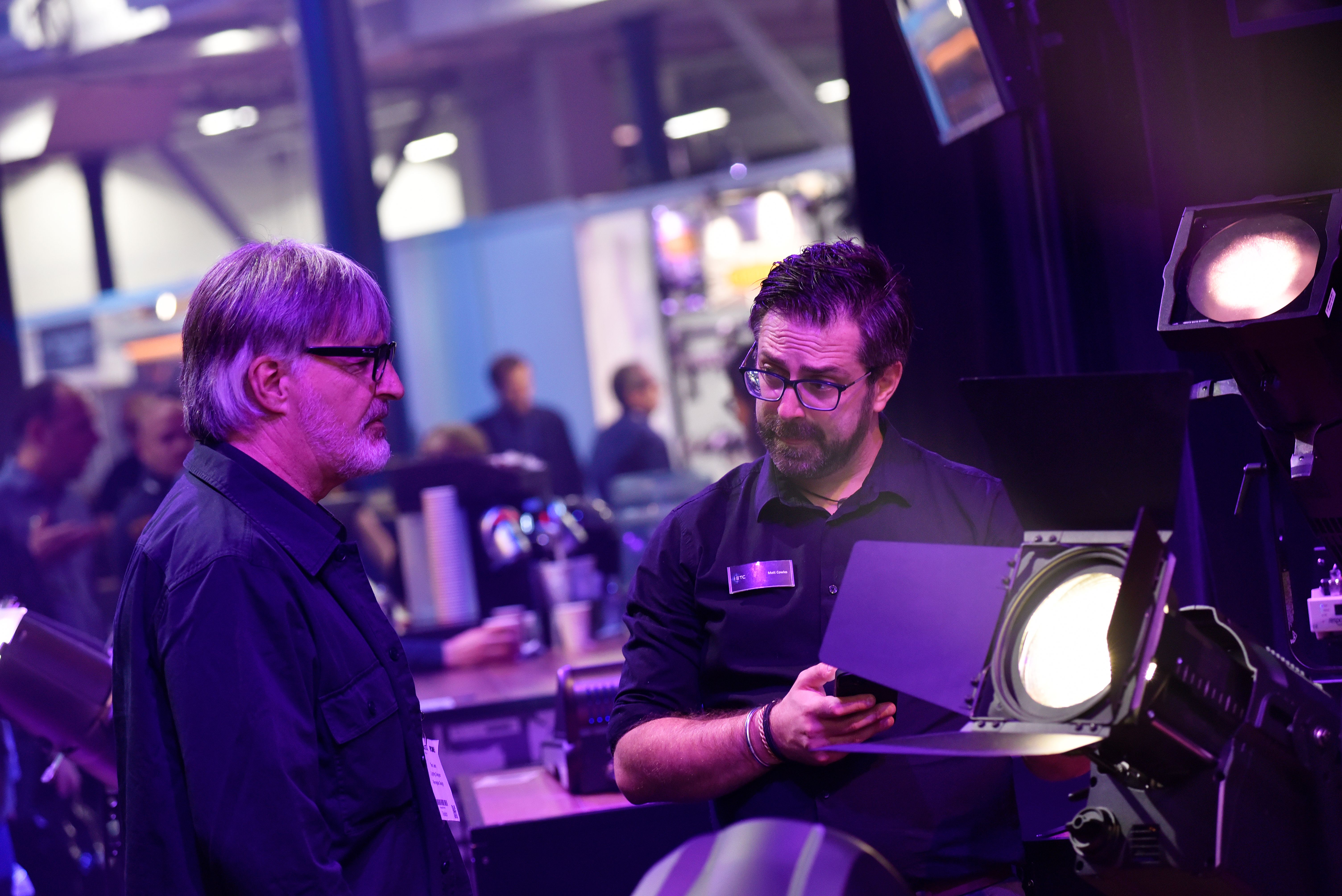 A Chauvet Professional representative speaking with a potential customer about stage lighting fixtures