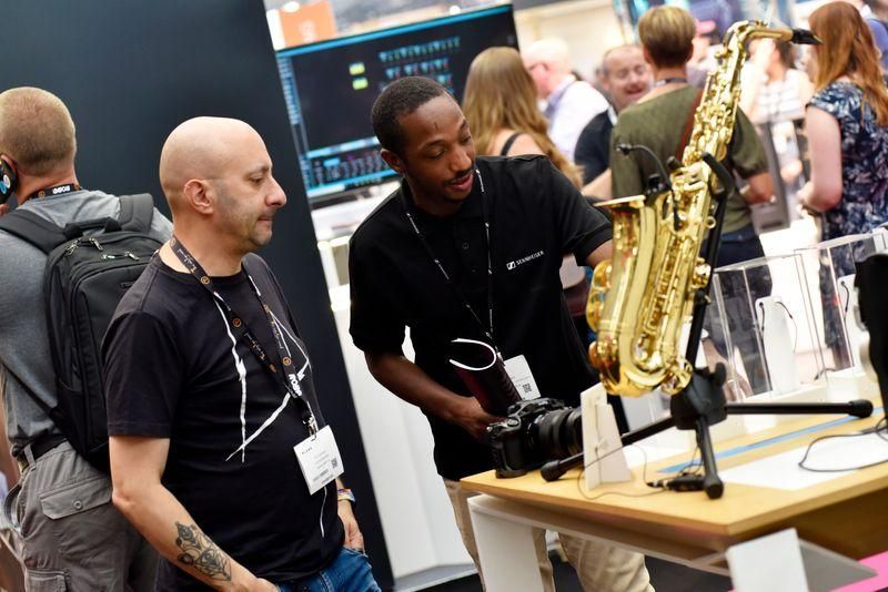 A Sennheiser representative speaking with a potential audio customer at PLASA Show 2022