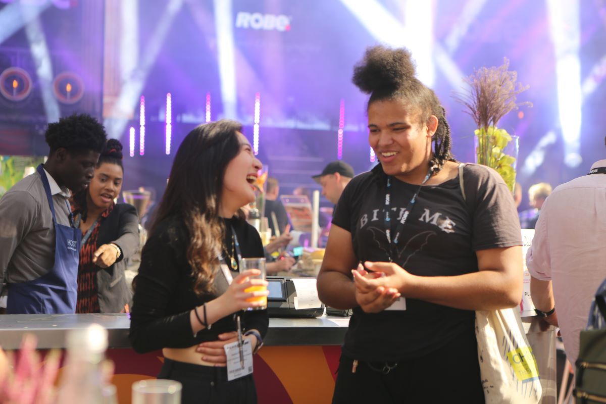 daphne chu laughing with female visitor at plasa show x we make events after party 2023