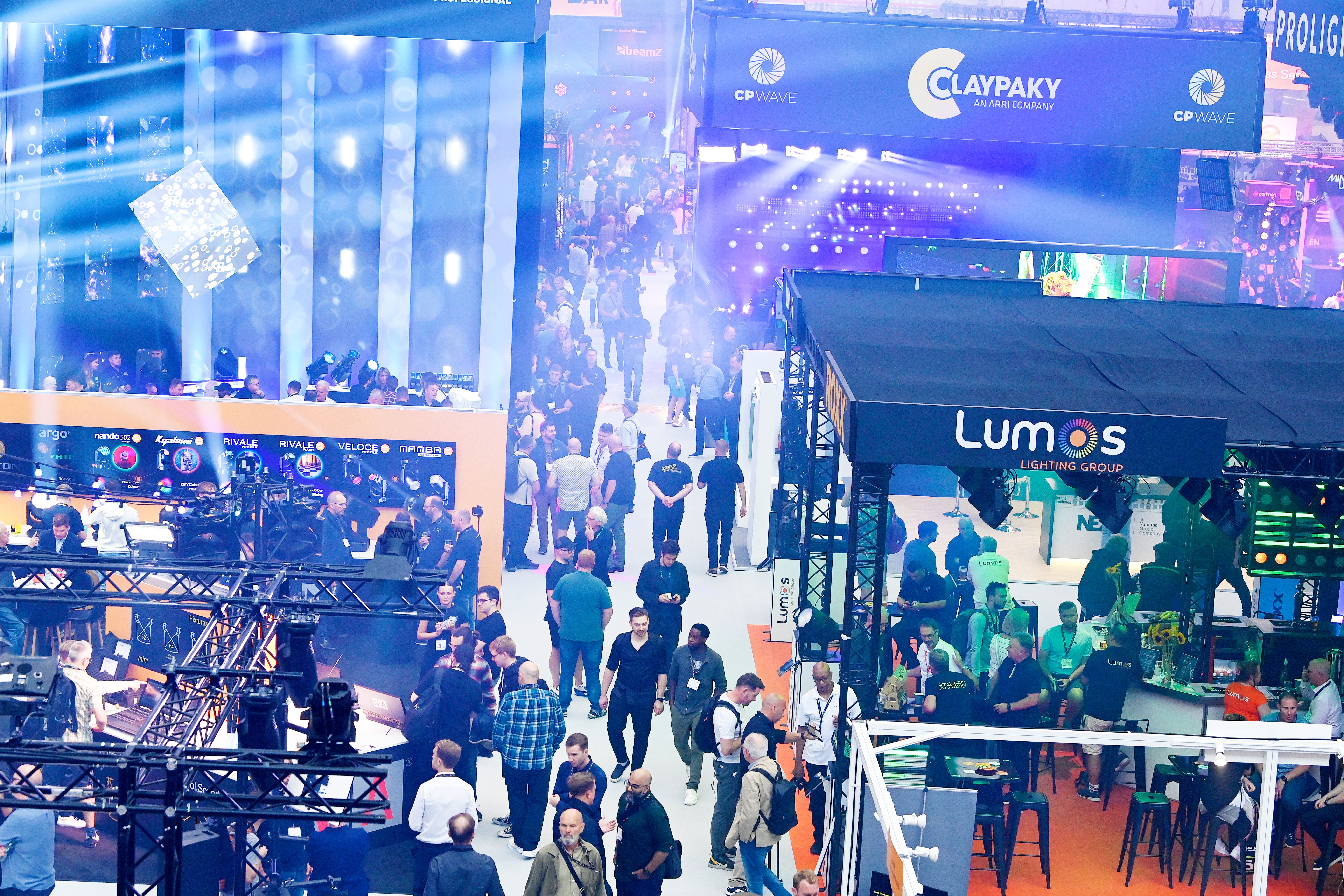 A crowd walking through plasa show aisle