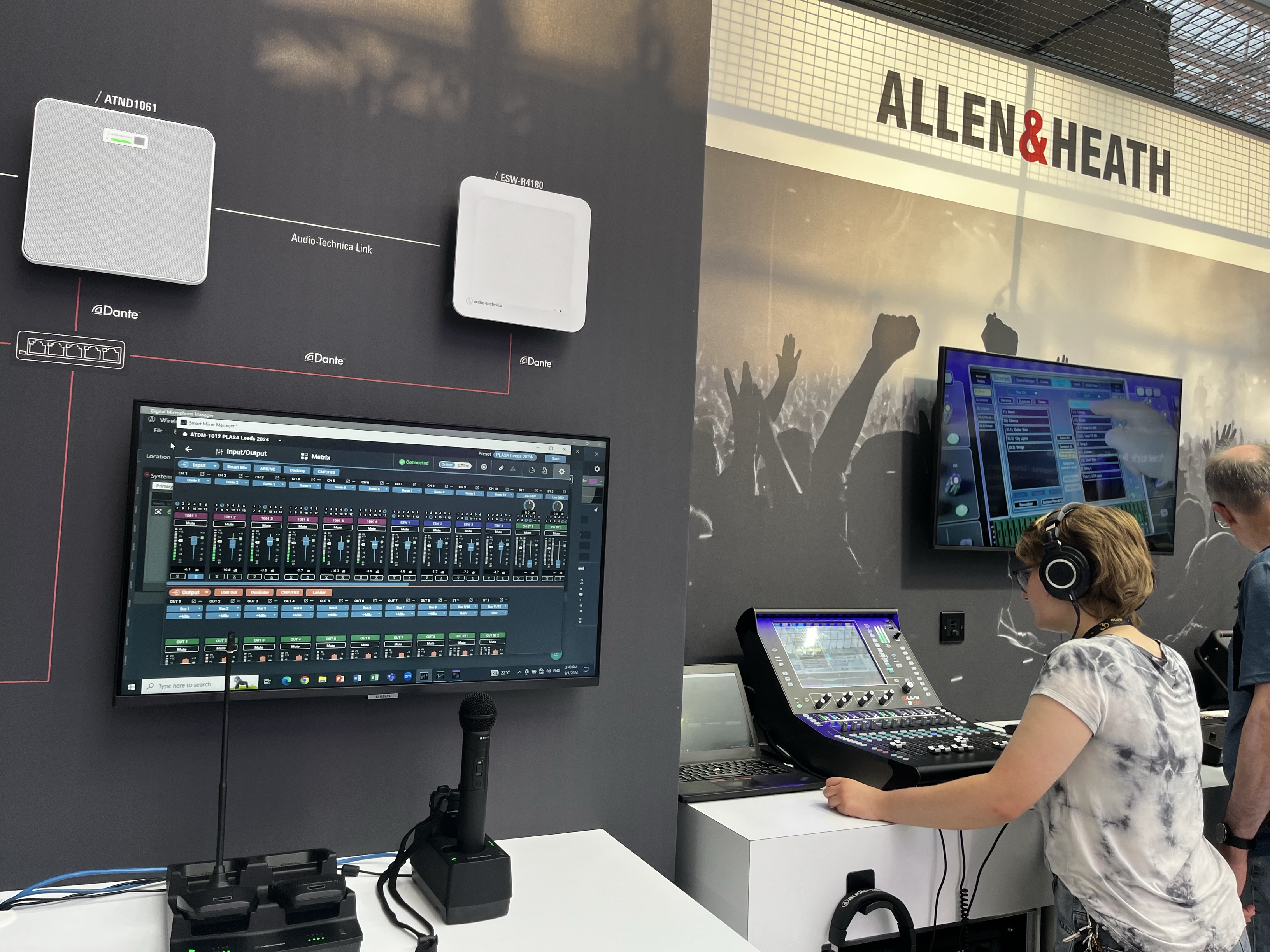 A woman using a sound desk on a Allen and heath exhibition stand