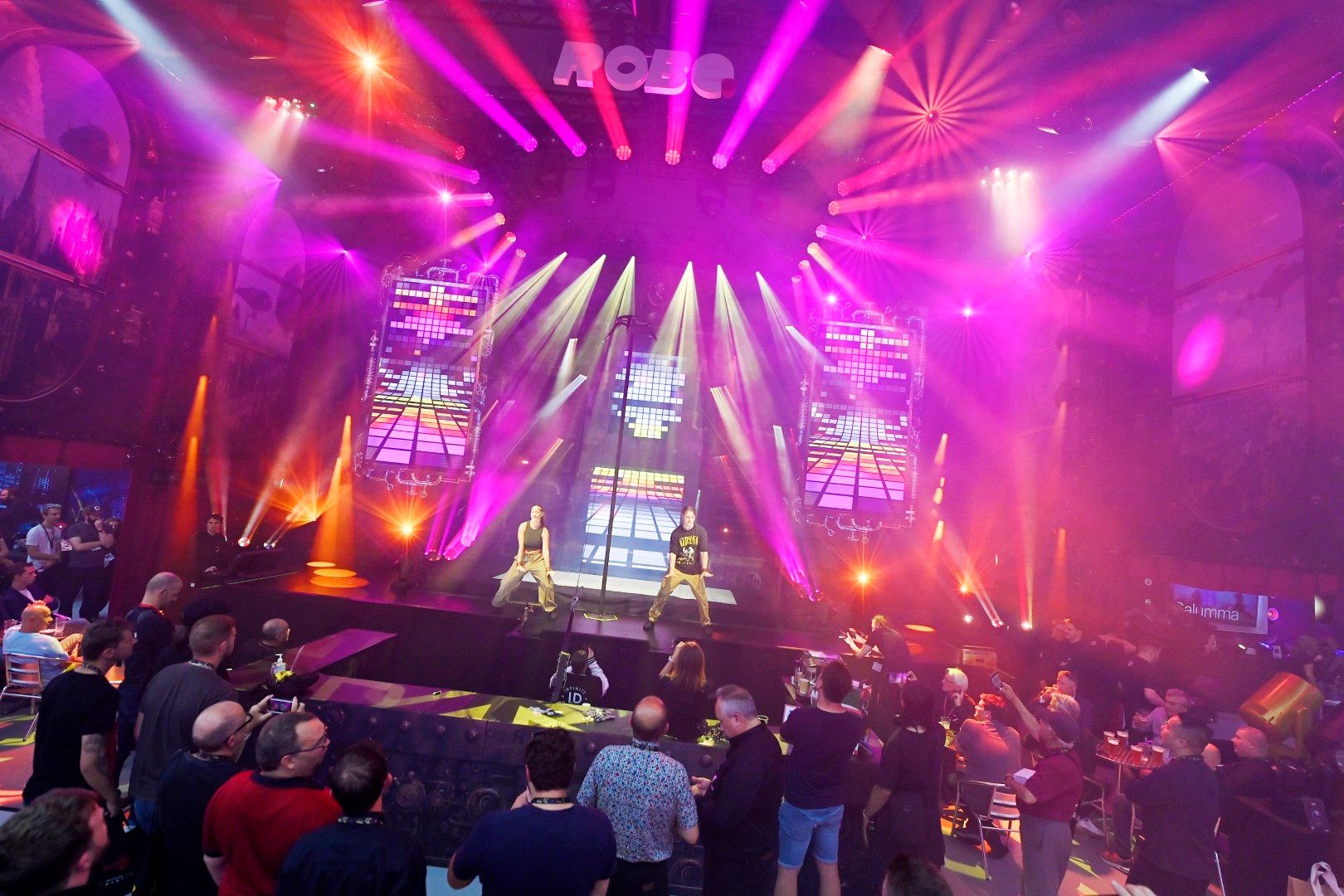 Male and female dancers performing on stage as part of Robe's lighting show at PLASA Show in London