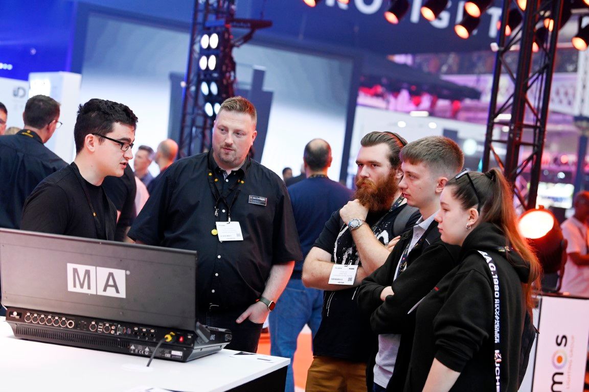 Young visitors talking to male ambersphere exhibitor plasa show 2024