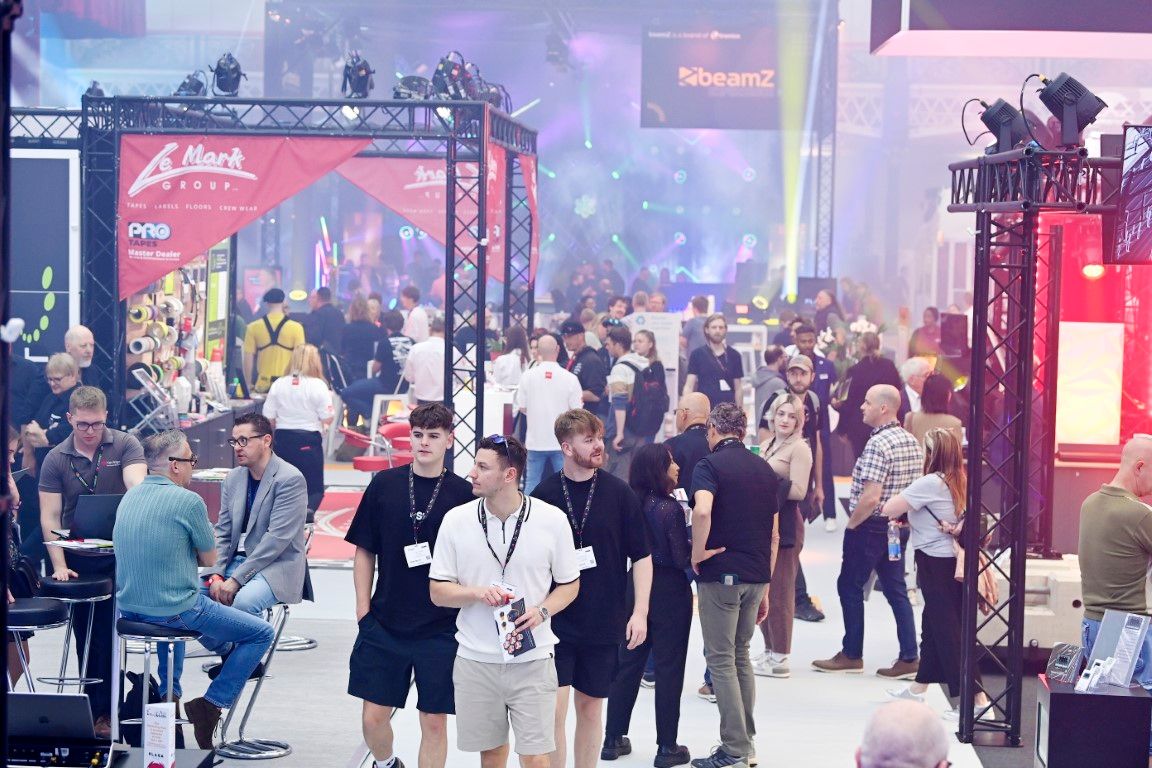 three male visitors walking through show floor at plasa show 2024